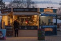 Saleswoman in stall with bee products at Christmas market