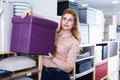 saleswoman suggesting new stylish hassock