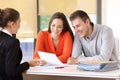 Saleswoman talking with customers at office