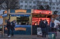 Saleswoman and visitors of punch bar at Christmas market