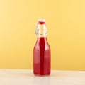 Salgam or fermented beet juice in bottle. Popular Turkish drink. Yellow background, copy space