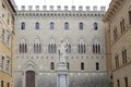 Salimbeni palace and Sallustio Bandini statue, Siena, Tuscany, Italy Royalty Free Stock Photo