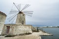 Salina windmill in Trapani, Sicily, Italy. Royalty Free Stock Photo