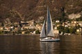 Lake - Lago di Como. Moltrasio village on the west shore of the lake and sailing boat. Royalty Free Stock Photo