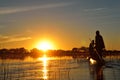 Saling in the Okavango delta at sunset, Botswana Royalty Free Stock Photo
