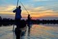 Saling in the Okavango delta at sunset, Botswana Royalty Free Stock Photo