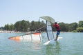 Salior trying to right catamaran after capsize Royalty Free Stock Photo