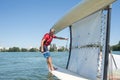 Salior trying to right catamaran after capsize Royalty Free Stock Photo