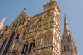 Salisbury Cathedral looking up at the Great West front with the spire in the background on a clear, sunny spring day Royalty Free Stock Photo