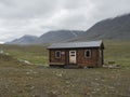 Salka, Norrbotten, Sweden, Agust 26, 2019: View on Salka STF mountain cabin hut. Green hills, and water puddles, cloudy rainy day