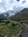 A young group of international hikers, led by their local Inca guide, navigate the Andes mountains on the Salkantay Trail