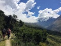 A young group of international hikers, led by their local Inca guide, navigate the Andes mountains on the Salkantay Trail