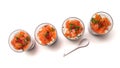 salmon appetizers in little glasses on top view on white background