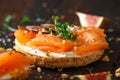 Salmon Bagel Sandwich with figs, cress salad, walnuts, cream cheese and grain on rustic wooden background. healthy Royalty Free Stock Photo