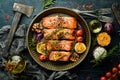 Salmon baked in a metal tray with vegetables and rosemary. Recipe. Seafood.
