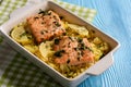 Salmon baked on oven with rice and lemon.