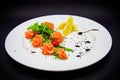 Salted salmon with garnish on black background