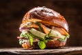 Salmon burger stuffed with vegetable salad avocado and dill