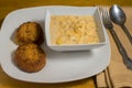 salmon cakes with a bowl of lobster mac and cheese