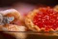 Salmon caviar in a tartlet on a glass dish. Festive table setting