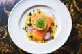 salmon ceviche in a lemon half with dill and capers Royalty Free Stock Photo