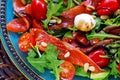 Salmon, cherry tomatoes, arugula salad, pine nuts, mozzarella