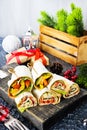 Salmon and cream cheese wraps. Rolls with smoked salmon, basil and rocket salad. Burrito on serving board Royalty Free Stock Photo