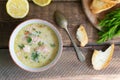 Salmon and cream fish soup in a white bowl with a spoon and a few slices of bread. Lohikeitto Royalty Free Stock Photo