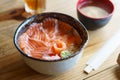 Salmon Donburi serve with miso soup on wooden table Royalty Free Stock Photo