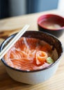 Salmon Donburi serve with miso soup on wooden table Royalty Free Stock Photo