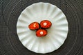 Salmon eggs or Ikura in Japanese style sushi fresh from raw salmond fish served on a white plate on dark background Royalty Free Stock Photo