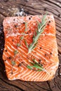 Salmon filet on a wooden carving board.