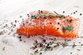 Salmon filet on a wooden carving board.