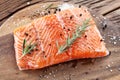 Salmon filet on a wooden carving board.