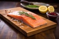 salmon fillet on cedar plank with rosemary sprigs Royalty Free Stock Photo