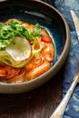 Salmon fillet ceviche with marinated, green, parsley, onion on blue plate Royalty Free Stock Photo