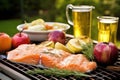 salmon fillet grilling, fresh apple cider sauce in foreground