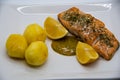 Salmon fillet seasoned with sea salt and dill with a honey mustard sauce and two lemons