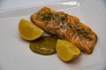 Salmon fillet seasoned with sea salt and dill with a honey mustard sauce and two lemons