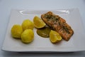 Salmon fillet seasoned with sea salt and dill with a honey mustard sauce and two lemons