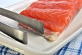 Salmon fillet and a tongs Royalty Free Stock Photo