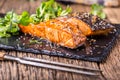 Salmon fillets. Grilled salmon, sesame seeds herb decorationon on vintage pan or black slate board. Royalty Free Stock Photo