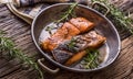 Salmon fillets. Grilled salmon, sesame seeds herb decorationon on vintage pan or black slate board. Royalty Free Stock Photo