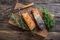 Salmon fillets. Grilled salmon, sesame seeds herb decorationon on vintage pan or black slate board. Royalty Free Stock Photo