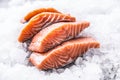 Salmon fillets portioned on ice and empty kitchen board Royalty Free Stock Photo