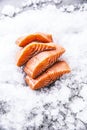 Salmon fillets portioned on ice and empty kitchen board Royalty Free Stock Photo