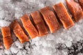 Salmon fillets portioned on ice and empty kitchen board Royalty Free Stock Photo