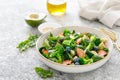 Salmon fish and avocado salad with fresh spinach leaves, broccoli, blueberry dressed with olive oil