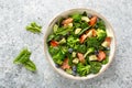 Salmon fish and avocado salad with fresh spinach leaves, broccoli, blueberry dressed with olive oil