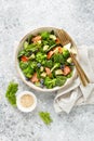 Salmon fish and avocado salad with fresh spinach leaves, broccoli, blueberry dressed with olive oil